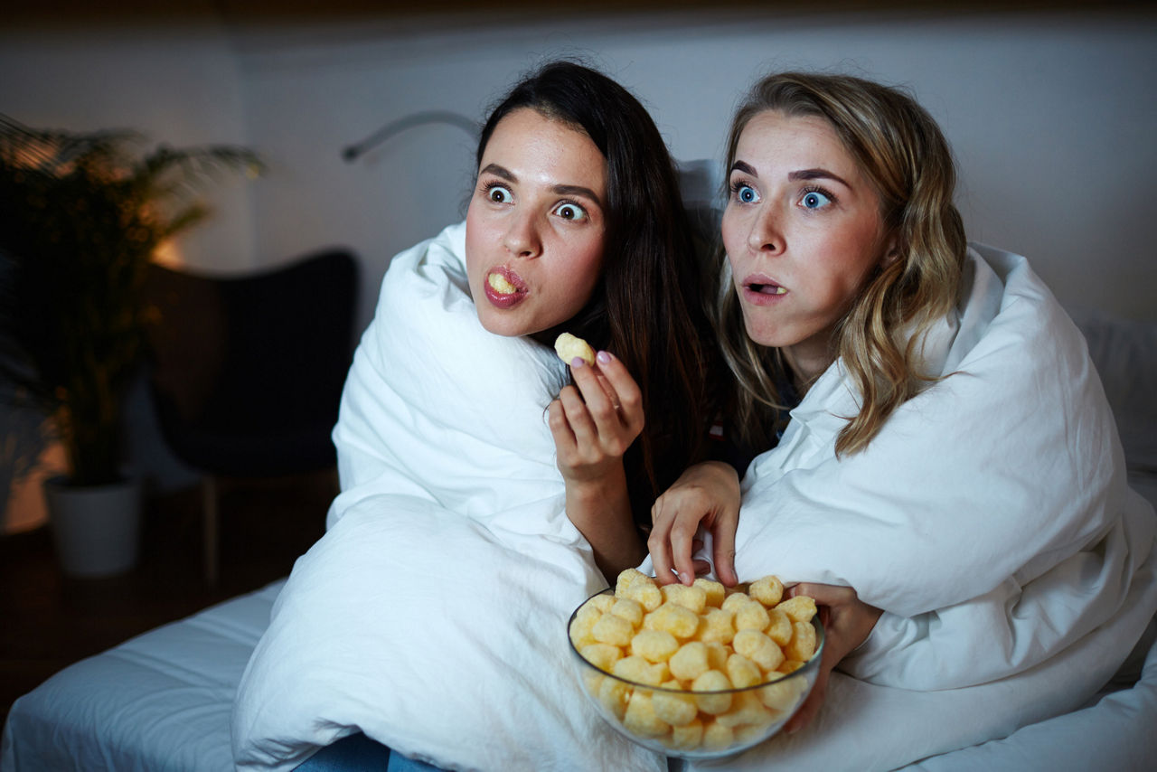 Two friends watching a movie and scared | Blog | Greystar 
